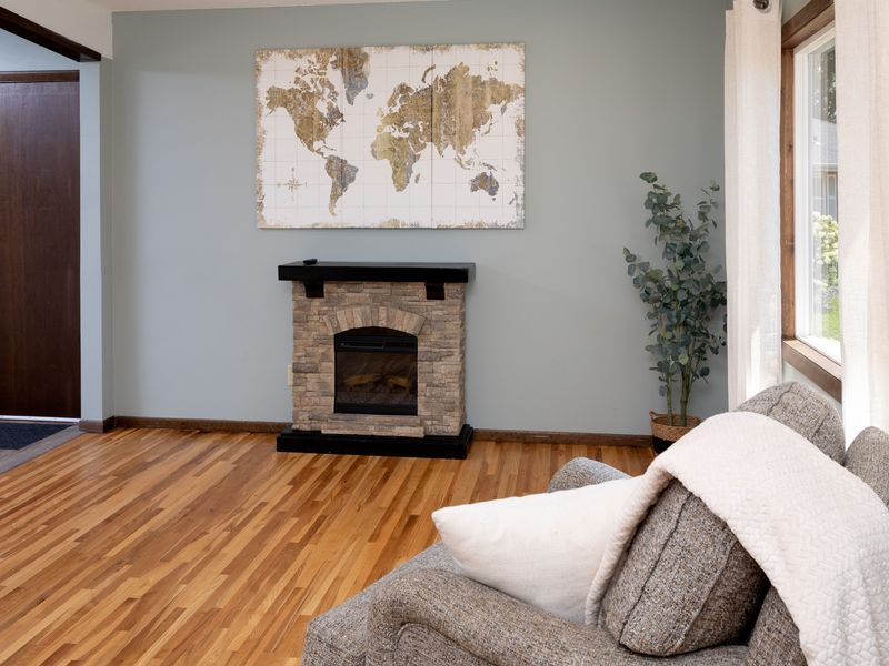 Electric fireplace with stacked-stone surround adds year-round ambiance