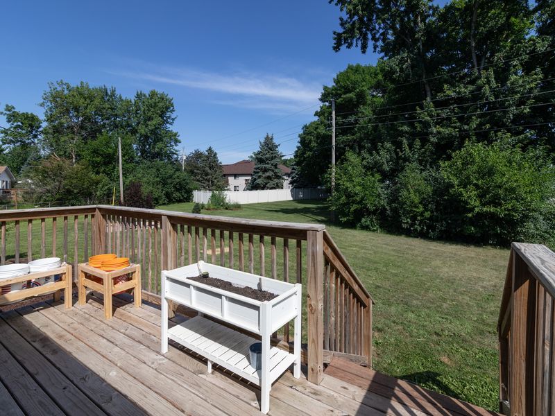 Deck off the dining room overlooks the huge, tree-lined backyard