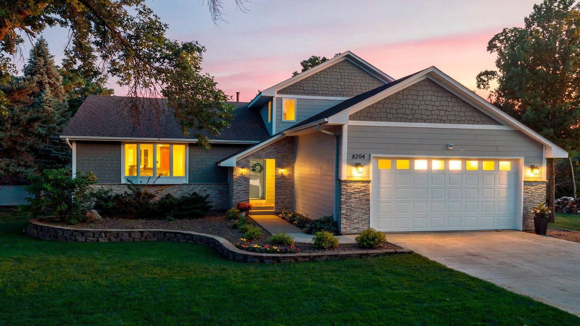 8204 Horizon Drive at dusk, updated two story with stone accents and landscaped front yard