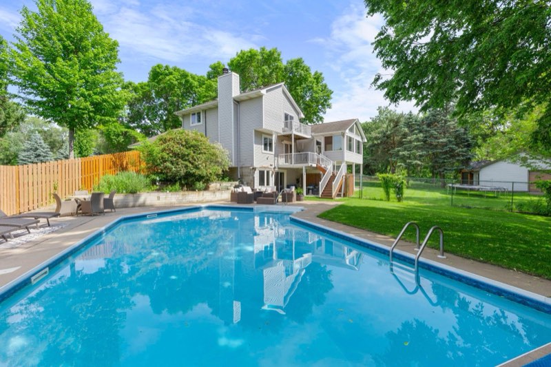 Escape to your own backyard retreat, where a sparkling pool, expansive outdoor living space, and a private tree-lined setting create the perfect place to entertain or unwind
