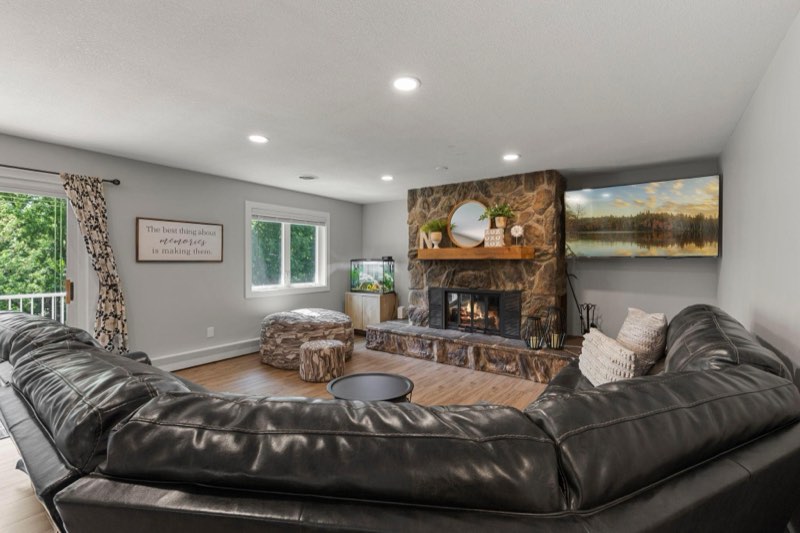 Family room is centered around a grand stone fireplace
