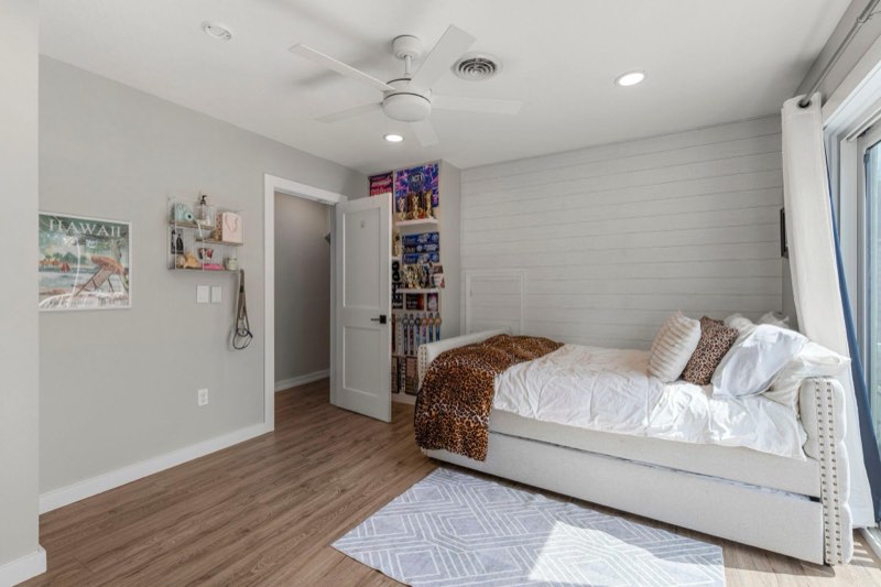 Upper level bedroom 2 could also be used as a primary bedroom and offers an ensuite bath, walk-in closet and private balcony